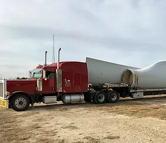 A red truck is parked on the side of the road.