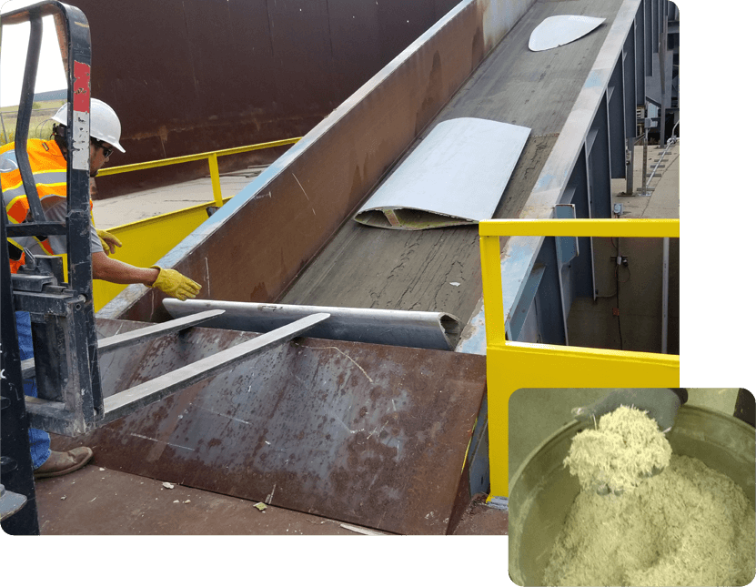 A man is working on the top of a conveyor belt.