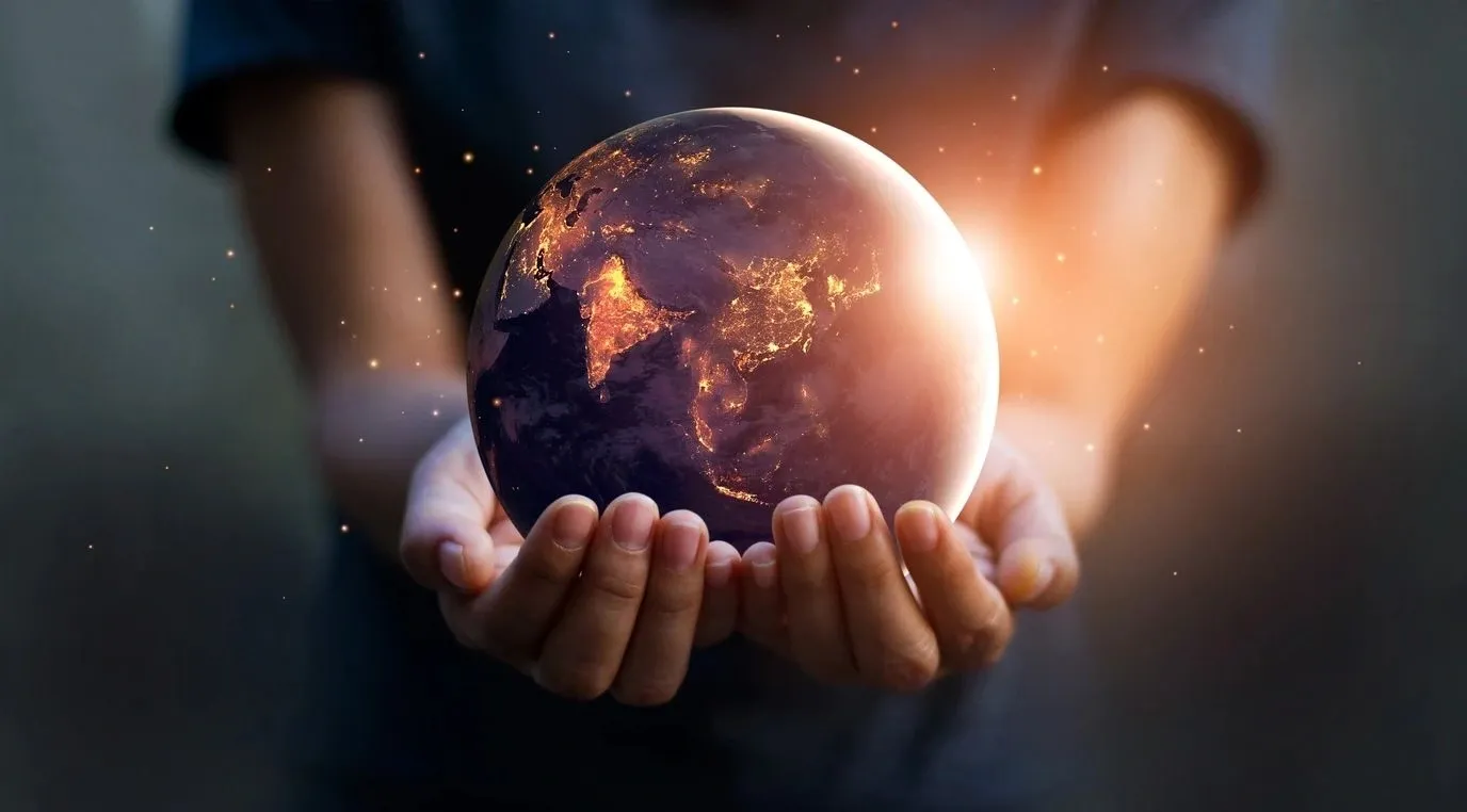 A person holding a globe in their hands.