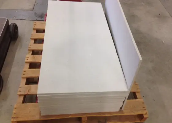 A pallet of white paper on top of wooden pallets.